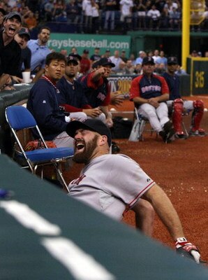ST PETERSBURG, FL - OCTOBER 19:  Kevin Youkilis #20 of the Boston Red Sox reacts after attempting to catch a fould ball hit by the Tampa Bay Rays in game seven of the American League Championship Series during the 2008 MLB playoffs on October 19, 2008 at 