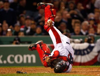 BOSTON - OCTOBER 13:  Catcher Jason Varitek #33 of the Boston Red Sox holds onto the ball after tagging out Carl Crawford (not pictured) of the Tampa Bay Rays at a play at the plate during game three of the American League Championship Series during the 2
