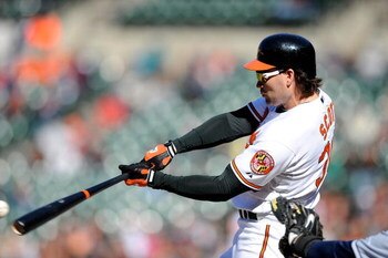 BALTIMORE - APRIL 12:  Luke Scott #30 of the Baltimore Orioles hits a single in the ninth inning against the Tampa Bay Rays on April 12, 2009 in Baltimore, Maryland.  (Photo by Greg Fiume/Getty Images)