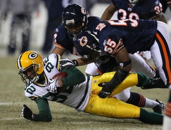 CHICAGO - DECEMBER 22: Lance Briggs #55 and Kevin Payne #44 of the Chicago Bears bring down Ruvell Martin #82 of the Green Bay Packers on December 22, 2008 at Soldier Field in Chicago, Illinois.  The Bears defeated the Packers 20-17 in overtime. (Photo by