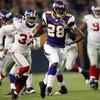 MINNEAPOLIS - DECEMBER 28:   Adrian Peterson #28 of the Minnesota Vikings runs the ball in for a touchdown as James Butler of the New York Giants defends on December 28, 2008 at the Hubert H. Humphrey Metrodome in Minneapolis, Minnesota. The Vikings defea