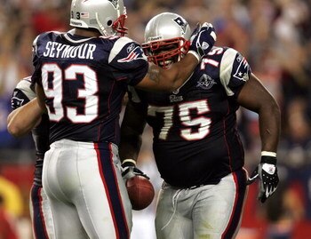 FOXBORO, MA - SEPTEMBER 8:  Defensive lineman Vince Wilfork #75 of the New England Patriots is congratulated by teammate Richard Seymour #93 after an interception against the Oakland Raiders during the 2005 NFL opening game at Gillette Stadium on Septembe