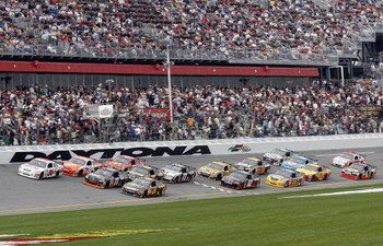 DAYTONA BEACH, FL - FEBRUARY 15:  David Ragan, driver of the #6 UPS Ford races Denny Hamlin, driver of the #11 FedEx Express Toyota, and Joey Logano, driver of the #20 Home Depot Toyota, during the NASCAR Sprint Cup Series Daytona 500 at Daytona Internati