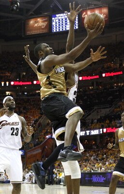 CLEVELAND - APRIL 21:  Gilbert Arenas #0 of the Washington Wizards gets to the basket past Joe Smith #32 and LeBron James #23 of the Cleveland Cavaliers in Game Two of the Eastern Conference Quarterfinals during the 2008 NBA Playoffs at Quicken Loans Aren