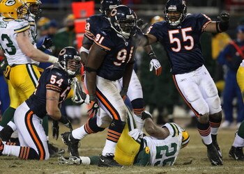 CHICAGO - DECEMBER 22: Tommie Harris #91 and Lance Briggs #55 of the Chicago Bears celebrate a tackle for a loss against Ryan Grant #25 of the Green Bay Packers on December 22, 2008 at Soldier Field in Chicago, Illinois. The Bears defeated the Packers 20-