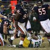 CHICAGO - DECEMBER 22: Tommie Harris #91 and Lance Briggs #55 of the Chicago Bears celebrate a tackle for a loss against Ryan Grant #25 of the Green Bay Packers on December 22, 2008 at Soldier Field in Chicago, Illinois. The Bears defeated the Packers 20-