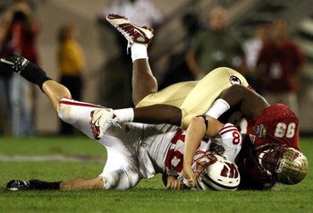 ORLANDO, FL - DECEMBER 27:  Quarterback Dustin Sherer #18 of the Wisconsin Badgers is tackled by Everette Brown #99 of the Florida State Seminoles during the Champs Bowl on December 27, 2008 at the Citrus Bowl in Orlando, Florida.  (Photo by Sam Greenwood