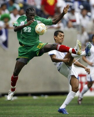 HOUSTON - JUNE 17: Loic Loval #22 of Guadeloupe goes for this ball against Amado Guevara #20 of Honduras during their quarterfinal match of the CONCACAF Gold Cup 2007 tournament at Reliant Stadium June 17, 2007 in Houston, Texas. Guadeloupe defeated Hondu