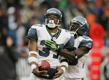 CHICAGO - JANUARY 14:  Running back Shaun Alexander #37 and wide receiver Deion Branch #83 of the Seattle Seahawks celebrate a play against the Chicago Bears during their NFC Divisional Playoff game on January 14, 2007 at Soldier Field in Chicago, Illinoi
