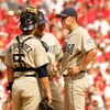 ST. LOUIS - OCTOBER 04:  Starting pitcher, Jake Peavy #44 of the San Diego Padres talks to pitching coach Darren Balsley and catcher, Ramon Hernandez #55 during Game One of the National League Divison Series against the St. Louis Cardinals at Busch Stadiu
