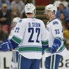 DETROIT - JANUARY 17:  The Sedin brothers Daniel #22 and Henrik #33 of the Vancouver Canucks chat prior to a faceoff in a game against the Detroit Red Wings on January 17, 2008 at the Joe Louis Arena in Detroit, Michigan. The Wings defeated the Canucks 3-