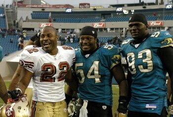 San Francisco 49ers  fullback Terry Jackson (22) greets Jacksonville Jaguars Mike Peterson (54) and defensive  end Bobby McCray (93)  December 18, 2005 in Jacksonville.   The three players are University of Florida graduates.   The Jaguars defeated the 49