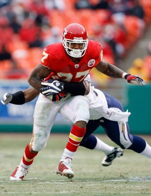 KANSAS CITY, MO - DECEMBER 14:  Larry Johnson #27 of the Kansas City Chiefs tries to break a tackle against the San Diego Chargers during the first half on December 14, 2008 at Arrowhead Stadium in Kansas City, Missouri. The Chiefs lost 22-21.  (Photo by 