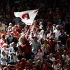 PHOENIX - MAY 30:  Fans of the Arizona Diamondbacks cheer and wave a team flag during the tenth inning of the major league baseball game against the Atlanta Braves at Chase Field on May 30, 2009 in Phoenix, Arizona. The Diamondbacks defeated the Braves 3-
