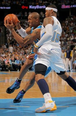 DENVER - APRIL 29:   David West #30 of the New Orleans Hornets drives against  Carmelo Anthony # 15 of the Denver Nuggets in Game Five of the Western Conference Quarterfinals during the 2009 NBA Playoffs at Pepsi Center on April 29, 2009 in Denver, Colora