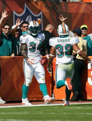 MIAMI - NOVEMBER 09:  Running back Ricky Williams #34 and Patrick Cobbs #38 of the Miami Dolphins celebrate a 51 yard touchdown run by Williams while facing the Seattle Seahawks at Dolphin Stadium on November 9, 2008 in Miami, Florida. The Dolphins defeat