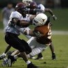 AUSTIN, TX - AUGUST 31:  Linebacker Brian Robison #39 of the University of Texas at Austin Longhorns tackles Keith Mouton #6 of the New Mexico State University Aggies at Texas Memorial Stadium on August 31, 2003 in Austin, Texas. Texas defeated New Mexico