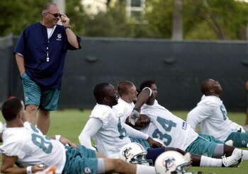 DAVIE, FL - JUNE 06:  Head coach Tony Sparano (L) watches running back Ricky Williams #34 stretch during Miami Dolphins Mini Camp on June 6, 2008 at the Dolphins practice facility in Davie, Florida.  (Photo by Marc Serota/Getty Images)