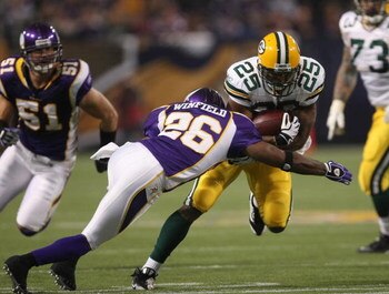 MINNEAPOLIS - NOVEMBER 09:  Running back Ryan Grant #25 of the Green Bay Packers carries the ball against cornerback Antoine Winfield #26 of the Minnesota Vikings on November 9, 2008 at the Metrodome in Mineapolis, Minnesota.  The Vikings won 28-27.  (Pho
