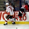 CHICAGO - APRIL 16:  Todd Bertuzzi #7 of the Calgary Flames checks Troy Brouwer #22 of the Chicago Blackhawks into the Flames' bench during Game One of the Western Conference Quarterfinals of the 2009 Stanley Cup Playoffs on April 16, 2009 at the United C