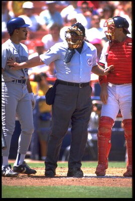 26 Apr 1992: AMERICAN LEAGUE UMPIRE, UMP ROCKY (MIDDLE) BREAKS UP SEATTLE MARINERS BATTER HENRY COTTO (LEFT) AND CALIFORNIA ANGELS CATCHER LANCE PARRISH (RIGHT) FROM ARGUING DURING THE ANGELS GAME AT ANAHEIM STADIUM IN ANAHEIM, CALIFORNIA.