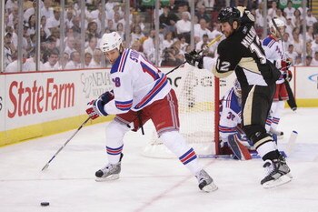 PITTSBURGH - APRIL 25: Marc Staal #18 of the New York Rangers holds off Ryan Malone #12 of the Pittsburgh Penguins as Staal attempts to control the puck during game one of the Eastern Conference Semifinals of the 2008 NHL Stanley Cup Playoffs on April 25,