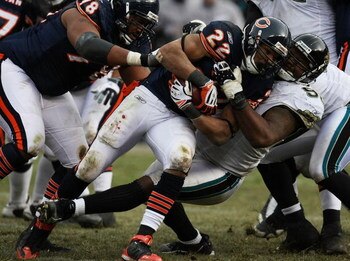 CHICAGO - DECEMBER 07: Matt Forte #22 of the Chicago Bears is tackled by Paul Spicer #95 of the Jacksonville Jaguars on December 7, 2008 at Soldier Field in Chicago, Illinois. The Bears defeated the Jaguars 23-10. (Photo by Jonathan Daniel/Getty Images)