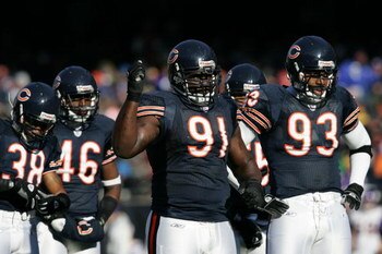 CHICAGO - DECEMBER 3:  Defensive tackle Tommie Harris #91 and defensive end Adewale Ogunleye #93 of the Chicago Bears stand on the field against the Minnesota Vikings on December 3, 2006 at Soldier Field in Chicago, Illinois. The Bears defeated the Viking
