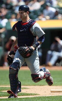 OAKLAND, CA - JUNE 11:  Joe Mauer #7 of the Minnesota Twins catches against the Oakland Athletics during a Major League Baseball game on June 11, 2009 at the Oakland Coliseum in Oakland, California.  (Photo by Jed Jacobsohn/Getty Images)