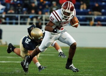 ANNAPOLIS, MD - NOVEMBER 19:  In this handout from the U.S. Navy, U.S. Naval Academy linebacker Jake Biles #52 falls short of tackling Temple Owls wide receiver Bruce Francis #82 of the Temple Owls during the second quarter November 19, 2005 at Navy Memor