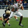 ANNAPOLIS, MD - NOVEMBER 19:  In this handout from the U.S. Navy, U.S. Naval Academy linebacker Jake Biles #52 falls short of tackling Temple Owls wide receiver Bruce Francis #82 of the Temple Owls during the second quarter November 19, 2005 at Navy Memor