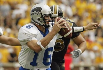 COLUMBIA, MO - SEPTEMBER 13:  Quarterback Andy Vincent #16 of Eastern Illinois scrambles as he is chased by Russ Bell #73 of Missouri on September 13, 2003 at Memorial Stadium in Columbia, Missouri.  Missouri defeated Eastern Illinois 37-0.  (Photo by Els
