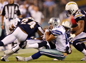SAN DIEGO - AUGUST 09:   Miles Austin #19 of the Dallas Cowboys is tackled by Antoine Cason #20 of the San Diego Chargers during a pre-season game at Qualcomm Stadium on August 9, 2008 in San Diego, California.  (Photo by Lisa Blumenfeld/Getty Images)