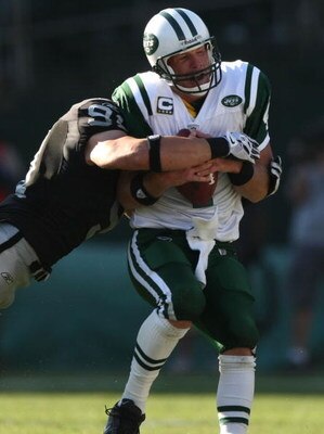OAKLAND, CA - OCTOBER 19:  Brett Favre #4 of the New York Jets is sacked by Trevor Scott #91 of the Oakland Raiders during an NFL game on October 19, 2008 at the Oakland-Alameda County Coliseum in Oakland, California.  (Photo by Jed Jacobsohn/Getty Images
