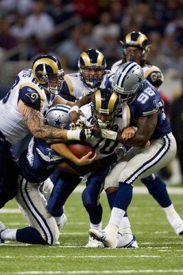 ST. LOUIS, MO - OCTOBER 19: Marc Bulger #10 of the St. Louis Rams is tackled by Greg Ellis #98 of the Dallas Cowboys at the Edward Jones Dome on October 19, 2008 in St. Louis, Missouri.  (Photo by Dilip Vishwanat/Getty Images)