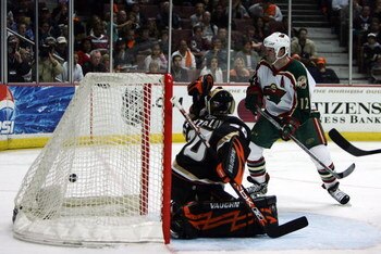 ANAHEIM, CA - APRIL 13:  Goaltender Ilya Bryzgalov #30 of the Anaheim Ducks allows a goal to Marian Gaborik #10 of the Minnesota Wild as Gaborik's teammate Brian Rolston #12 looks on in the second period to tie the game at 1-1 during game two of the 2007 
