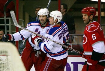 RALEIGH, NC - FEBRUARY 28:  Bret Hedican #6 of the Carolina Hurricanes looks on as Jaromir Jagr #68 and Brandon Dubinsky #17 of the New York Rangers celebrate Dubinsky's goal during the first period at RBC Center on February 28, 2008 in Raleigh, North Car