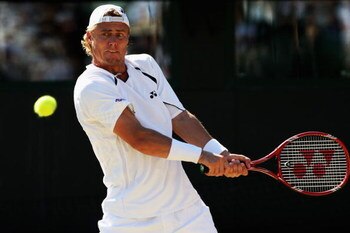 WIMBLEDON, ENGLAND - JULY 01:  Lleyton Hewitt of Australia plays a backhand during the men's singles quarter final match against Andy Roddick of USA on Day Nine of the Wimbledon Lawn Tennis Championships at the All England Lawn Tennis and Croquet Club on 