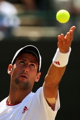 WIMBLEDON, ENGLAND - JULY 01:  Novak Djokovic of Serbia serves during the men's singles quarter final match against Tommy Haas of Germany on Day Nine of the Wimbledon Lawn Tennis Championships at the All England Lawn Tennis and Croquet Club on July 1, 200