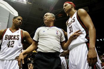 MILWAUKEE - FEBRUARY 20: Referee Luis Grillo #8 warns Charlie Villanueva #31 of the Milwaukee Bucks to stay off of the court after a melee broke out during a game between the Bucks and the Cleveland Cavaliers as teammate Charlie Bell #42 listens in on Feb