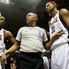 MILWAUKEE - FEBRUARY 20: Referee Luis Grillo #8 warns Charlie Villanueva #31 of the Milwaukee Bucks to stay off of the court after a melee broke out during a game between the Bucks and the Cleveland Cavaliers as teammate Charlie Bell #42 listens in on Feb