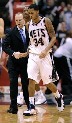 EAST RUTHERFORD, NJ - NOVEMBER 07:  Devin Harris #34 is helped from the court by Lawrence Frank, head coach of the New Jersey Nets during a game against of the Detroit Pistons November 7, 2008 at the Izod Arena in East Rutherford, New Jersey.  (Photo by J