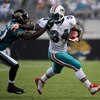JACKSONVILLE, FL - AUGUST 16:  Running back Ricky Williams #34 of the Miami Dolphins is tackled by Drayton Florence #21 of the Jacksonville Jaguars at Jacksonville Municipal Stadium on August 16, 2008 in Jacksonville, Florida.  (Photo by Sam Greenwood/Get