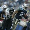 NASHVILLE, TN - NOVEMBER 16:  Eddie George #27 of the Tennessee Titans runs past Hugh Douglas #58 of the Jacksonville Jaguars on November 16, 2003 at The Coliseum in Nashville, Tennessee. The Titans won 10-3.  (Photo by Elsa/Getty Images)