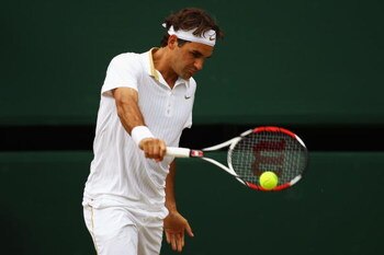 WIMBLEDON, ENGLAND - JULY 03:  Roger Federer of Switzerland plays a backhand during the men's singles semi final match against Tommy Haas of Germany on Day Eleven of the Wimbledon Lawn Tennis Championships at the All England Lawn Tennis and Croquet Club o