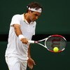 WIMBLEDON, ENGLAND - JULY 03:  Roger Federer of Switzerland plays a backhand during the men's singles semi final match against Tommy Haas of Germany on Day Eleven of the Wimbledon Lawn Tennis Championships at the All England Lawn Tennis and Croquet Club o