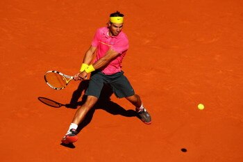 PARIS - MAY 29:  Rafael Nadal of Spain hits a backhand during his Men's Singles Third Round match against Lleyton Hewitt of Australia on day six of the French Open at Roland Garros on May 29, 2009 in Paris, France.  (Photo by Clive Brunskill/Getty Images)