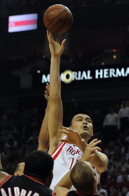 HOUSTON - APRIL 30:  Center Yao Ming #11 of the Houston Rockets takes a shot against Joel Przybilla #10 and LaMarcus Aldridge of the Portland Trail Blazers in Game Six of the Western Conference Quarterfinals during the 2009 NBA Playoffs at Toyota Center o