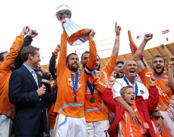 WASHINGTON - NOVEMBER 18:  Wade Barrett #24 of the Houston Dynamo holds up the trophy in celebration with his team after defeating the New England Revolution by a score of 2-1 to win the 2007 Major League Soccer Cup at RFK Stadium on November 18, 2007 in 