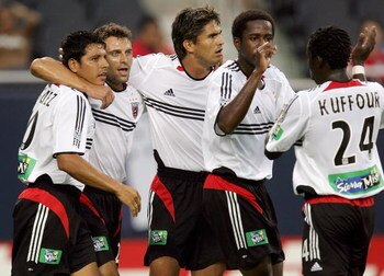 CHICAGO - JUNE 29:  (L-R) Christian Gomez #10,  Dema Kovalenko #21, Jaime Moreno #99, Clyde Simms #19 and Nana Kuffour #24 of D.C. United celebrate a goal against the Chicago Fire during their MLS game on June 29, 2005 at Soldier Field in Chicago, Illinoi